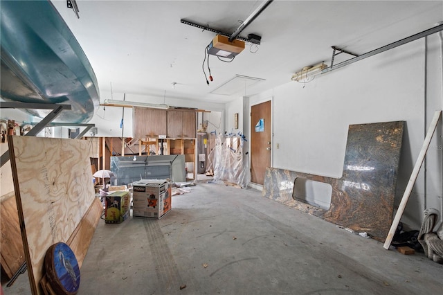 garage with electric water heater and a garage door opener