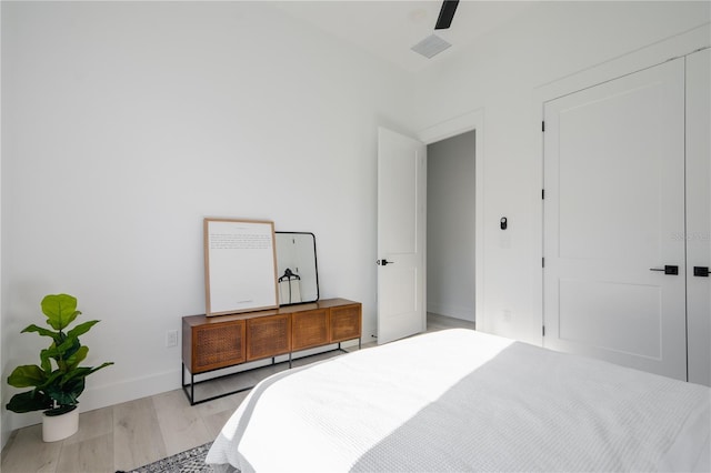 bedroom with ceiling fan and light hardwood / wood-style floors