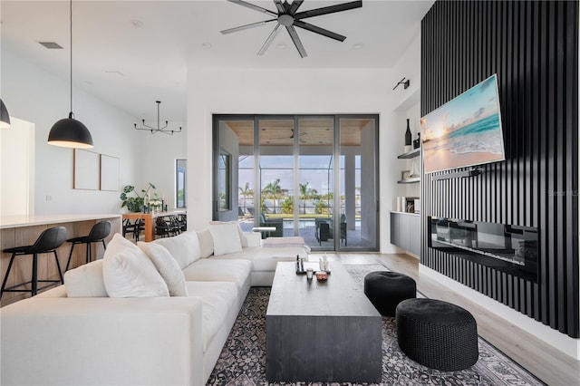 living room with wood-type flooring and ceiling fan