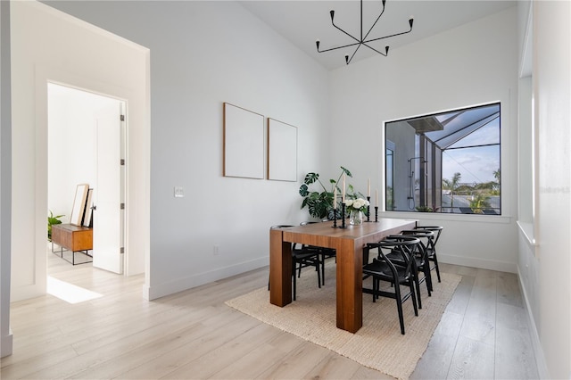 dining room with a notable chandelier and light hardwood / wood-style floors