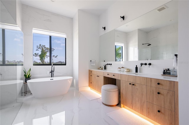 bathroom with vanity and independent shower and bath