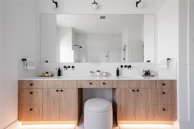 bathroom featuring vanity and a shower