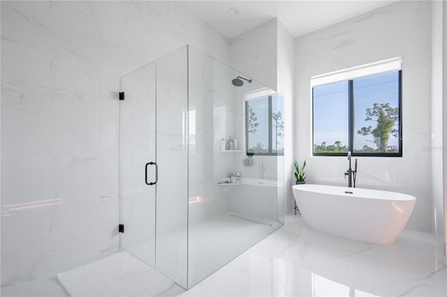 bathroom featuring shower with separate bathtub