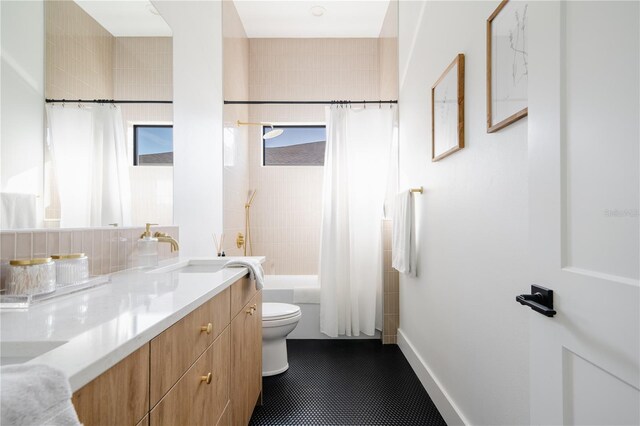 full bathroom featuring shower / bathtub combination with curtain, vanity, toilet, and tile patterned flooring