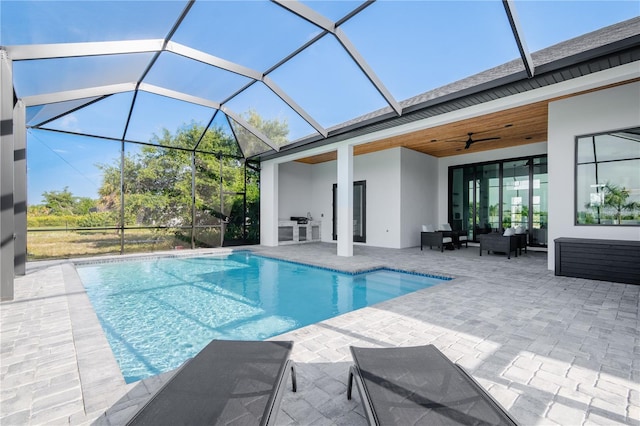 view of swimming pool featuring a lanai, an outdoor hangout area, a patio, and ceiling fan