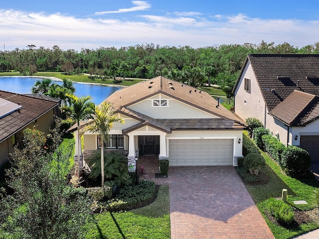 view of front facade featuring a garage and a water view