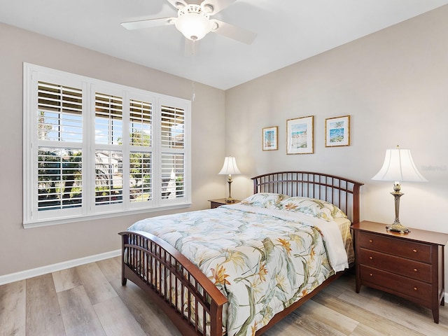 bedroom with ceiling fan and light hardwood / wood-style floors