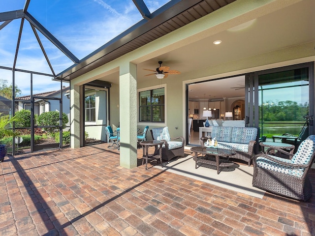 view of patio / terrace featuring outdoor lounge area, ceiling fan, and a lanai