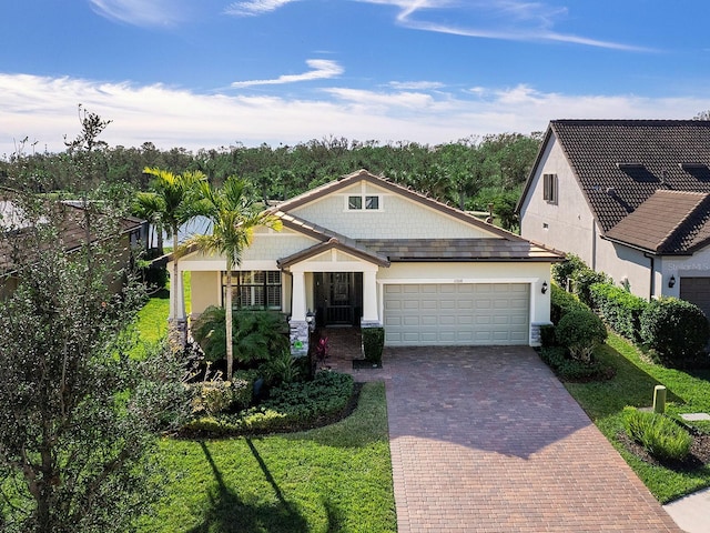 view of front of home with a front yard and a garage