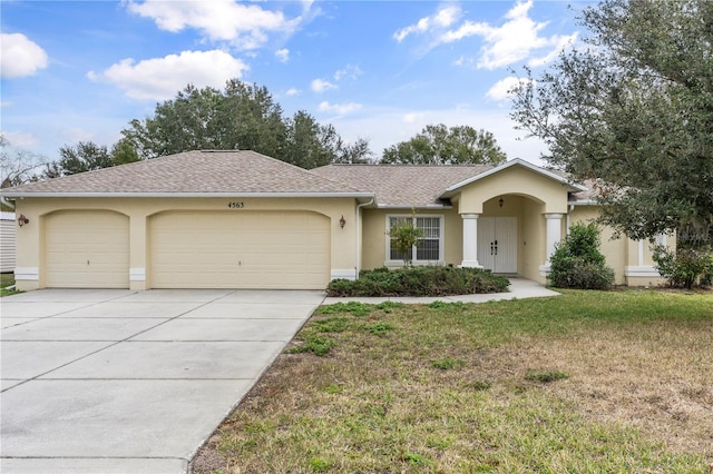 ranch-style home with a garage and a front yard