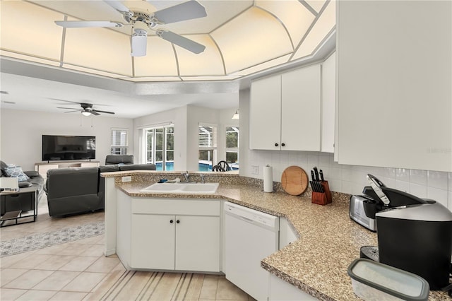 kitchen with white cabinetry, sink, kitchen peninsula, white dishwasher, and light tile patterned flooring