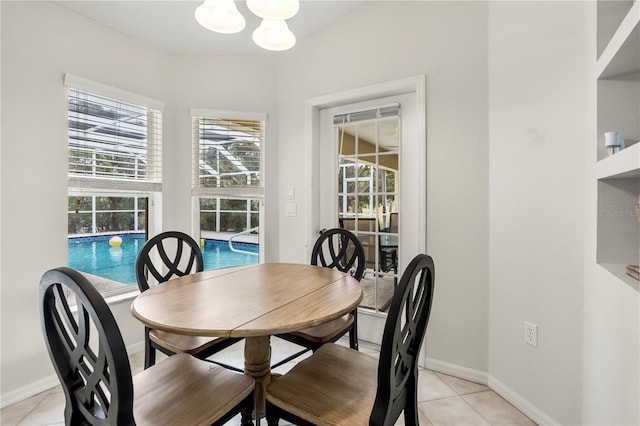 dining room featuring light tile patterned floors and an inviting chandelier