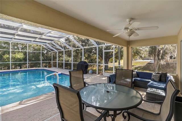 view of pool with an outdoor hangout area, ceiling fan, a lanai, area for grilling, and a patio