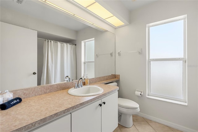 bathroom featuring tile patterned floors, vanity, and toilet