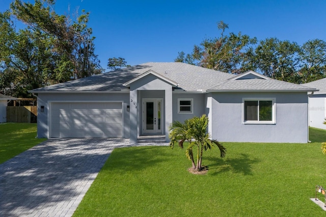 ranch-style home with a garage and a front lawn