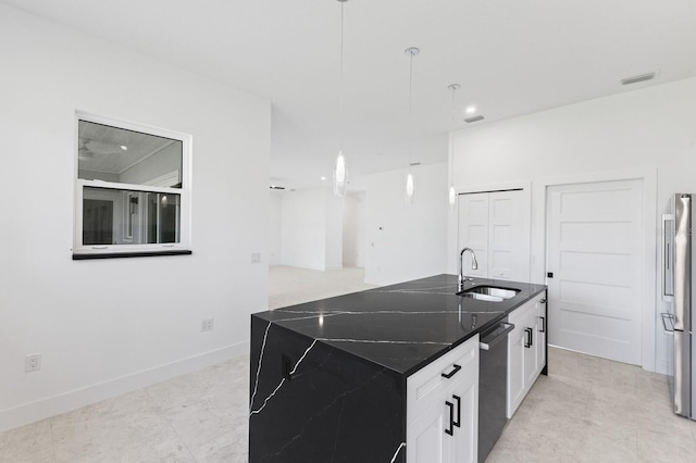 kitchen featuring pendant lighting, white cabinets, sink, an island with sink, and stainless steel appliances