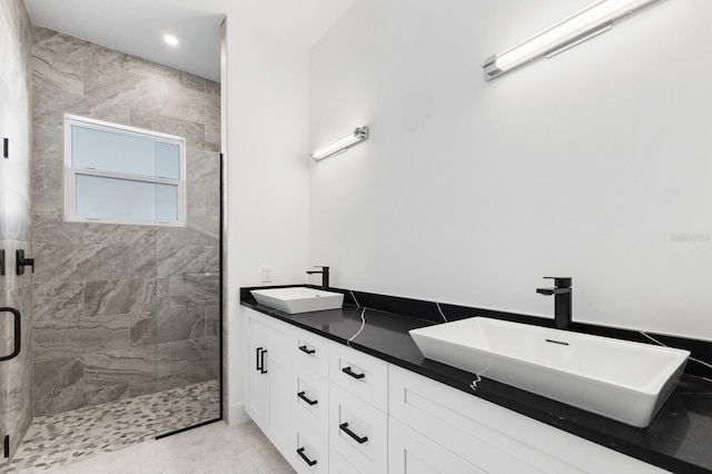 bathroom featuring tile patterned flooring, vanity, and a shower with shower door