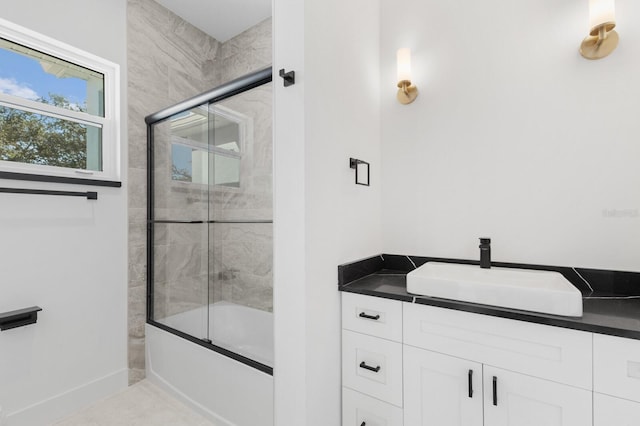 bathroom with vanity and enclosed tub / shower combo