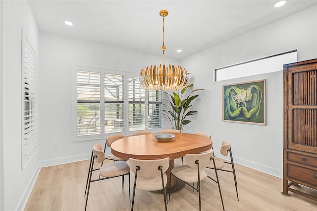 dining area featuring a notable chandelier and light hardwood / wood-style floors