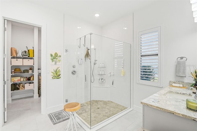 bathroom with vanity, tile patterned floors, and walk in shower