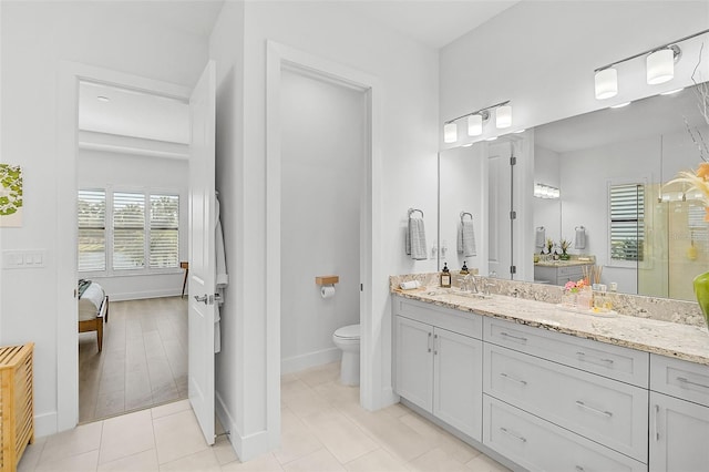 bathroom featuring tile patterned floors, vanity, and toilet