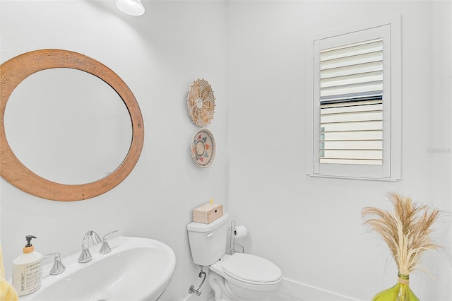 bathroom featuring toilet and sink