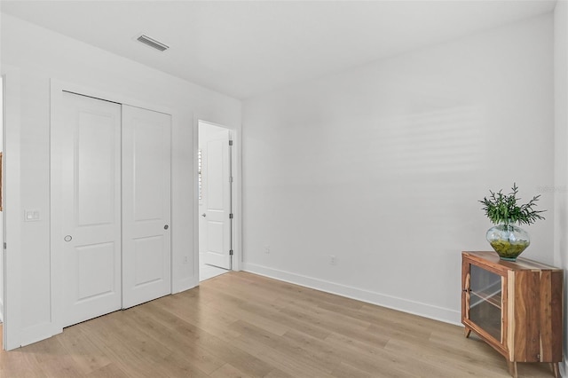 bedroom featuring light wood-type flooring and a closet