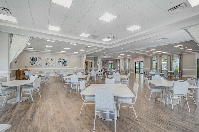 dining area with hardwood / wood-style floors, ceiling fan, and a paneled ceiling