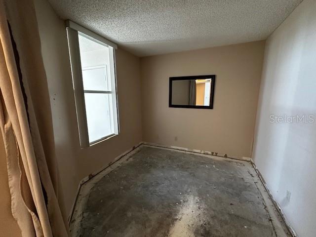 spare room with a textured ceiling