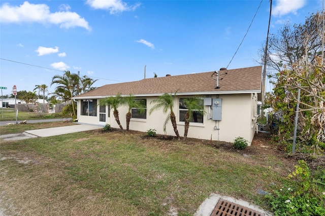 view of front facade with a patio and a front yard