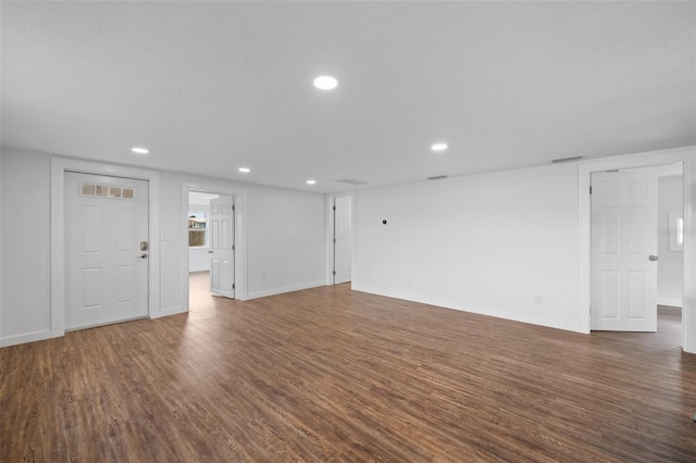 unfurnished living room with dark hardwood / wood-style flooring