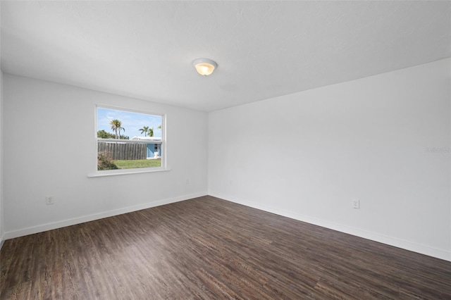 spare room with dark hardwood / wood-style flooring