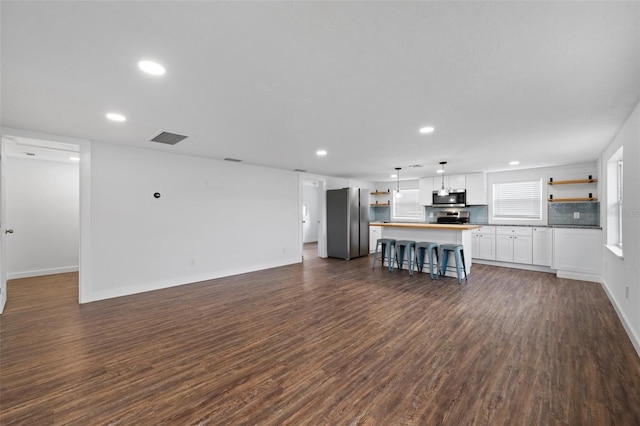 unfurnished living room with dark hardwood / wood-style flooring