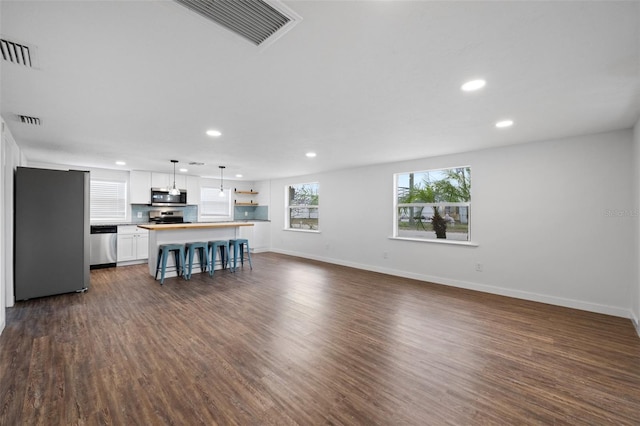 unfurnished living room with dark hardwood / wood-style floors