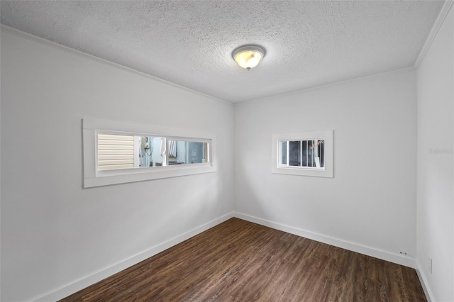 spare room featuring crown molding, dark hardwood / wood-style flooring, and a textured ceiling