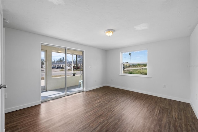 spare room with dark wood-type flooring