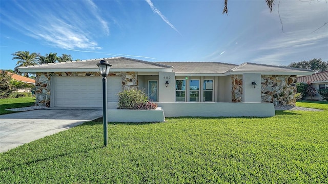 single story home featuring a garage and a front yard