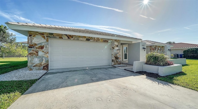 view of front facade with a front yard and a garage