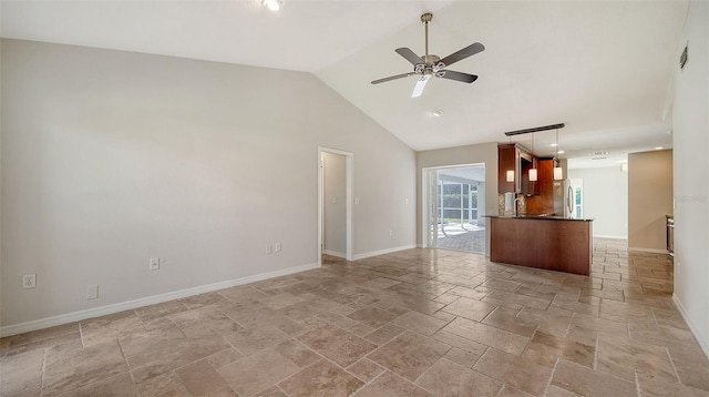 unfurnished living room with vaulted ceiling and ceiling fan