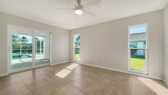 unfurnished room featuring ceiling fan and light tile patterned floors