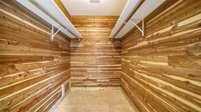 walk in closet with tile patterned floors