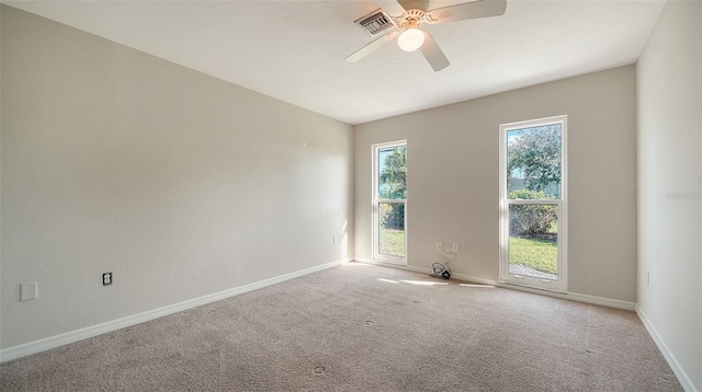 unfurnished room featuring light carpet and ceiling fan