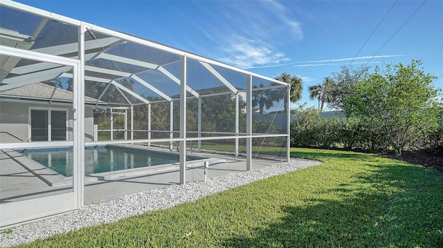 view of pool featuring glass enclosure and a yard