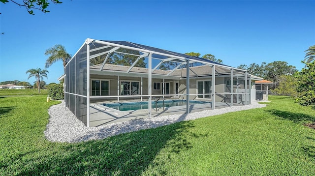 rear view of property with a patio, a lanai, and a lawn