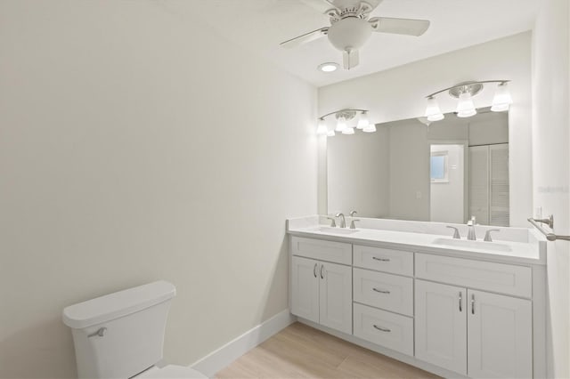 482 Rubens Dr E, Nokomis, FL 34275 - full bathroom featuring double vanity, wood finished floors, and a ceiling fan
