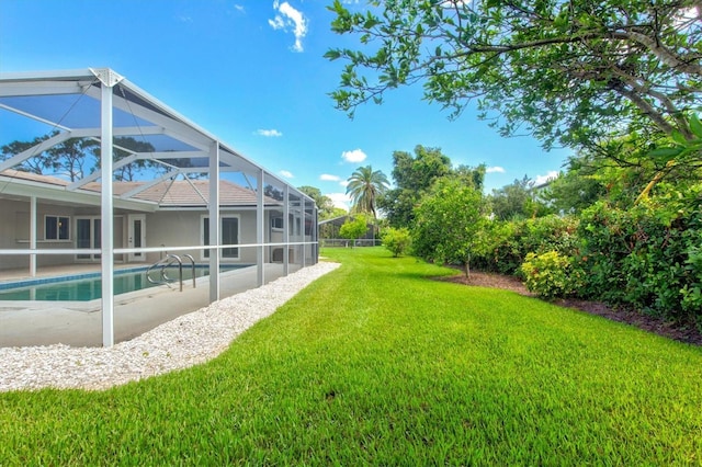 482 Rubens Dr E, Nokomis, FL 34275 - view of grassy yard with glass enclosure, an outdoor pool, and a patio area