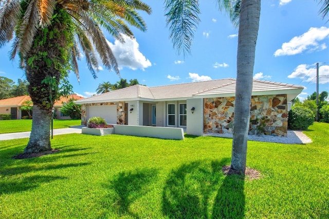 482 Rubens Dr E, Nokomis, FL 34275 - ranch-style home featuring stone siding, a garage, a front yard, and concrete driveway