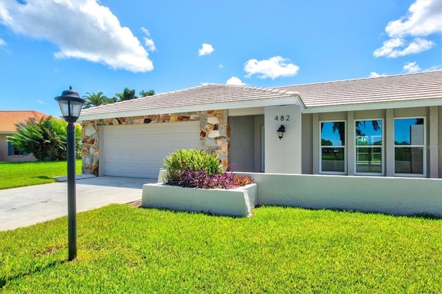 482 Rubens Dr E, Nokomis, FL 34275 - ranch-style house featuring a garage, driveway, a front lawn, stone siding, and stucco siding
