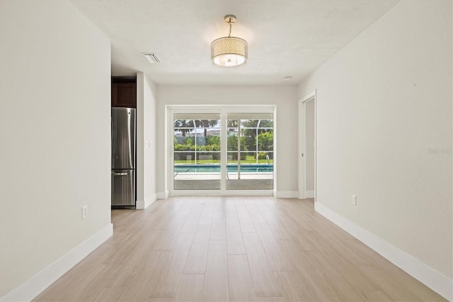 482 Rubens Dr E, Nokomis, FL 34275 - empty room featuring light wood-style flooring and baseboards