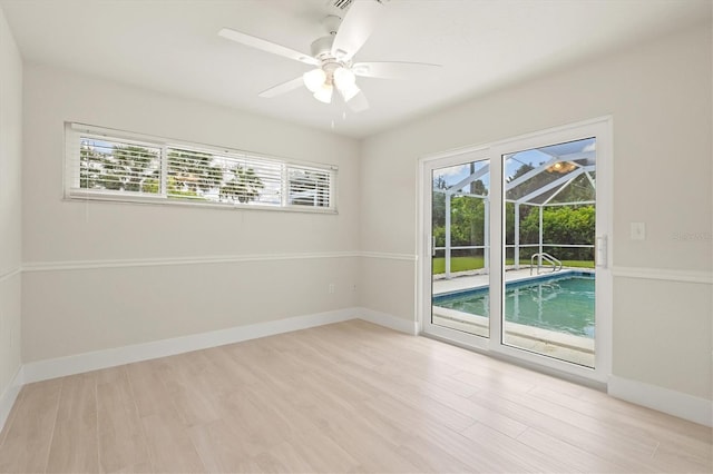 482 Rubens Dr E, Nokomis, FL 34275 - empty room with plenty of natural light, light wood-style flooring, ceiling fan, and a sunroom